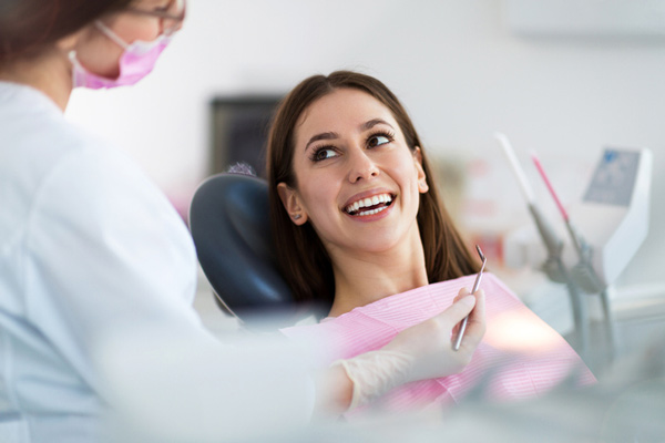 Woman leaning back in dental chair looking up at dentist, at Masci, Hale & Wilson Advanced Aesthetic and Restorative Dentistry in Montgomery, NY.